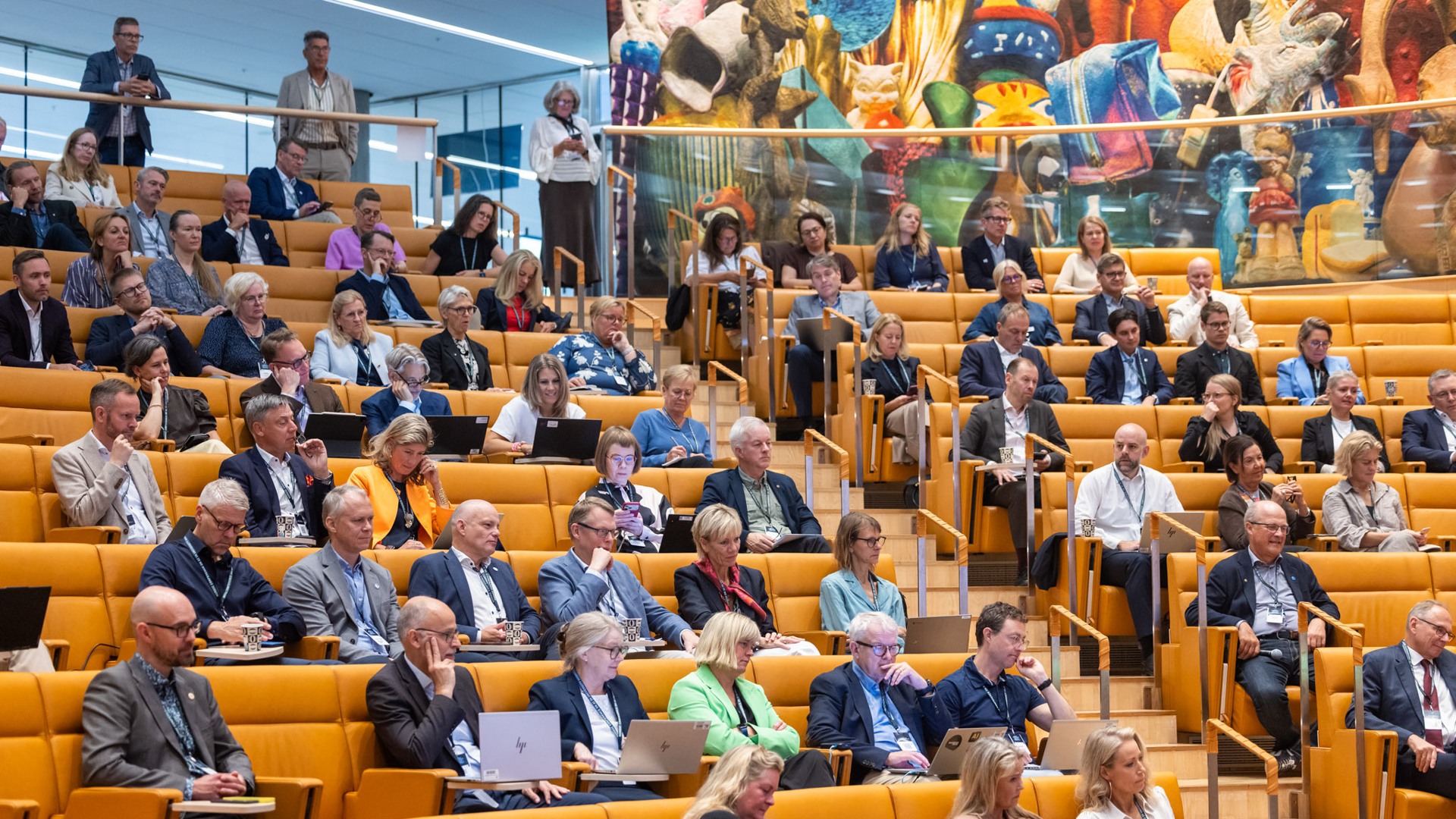 A large group of people sitting in a lecture hall.