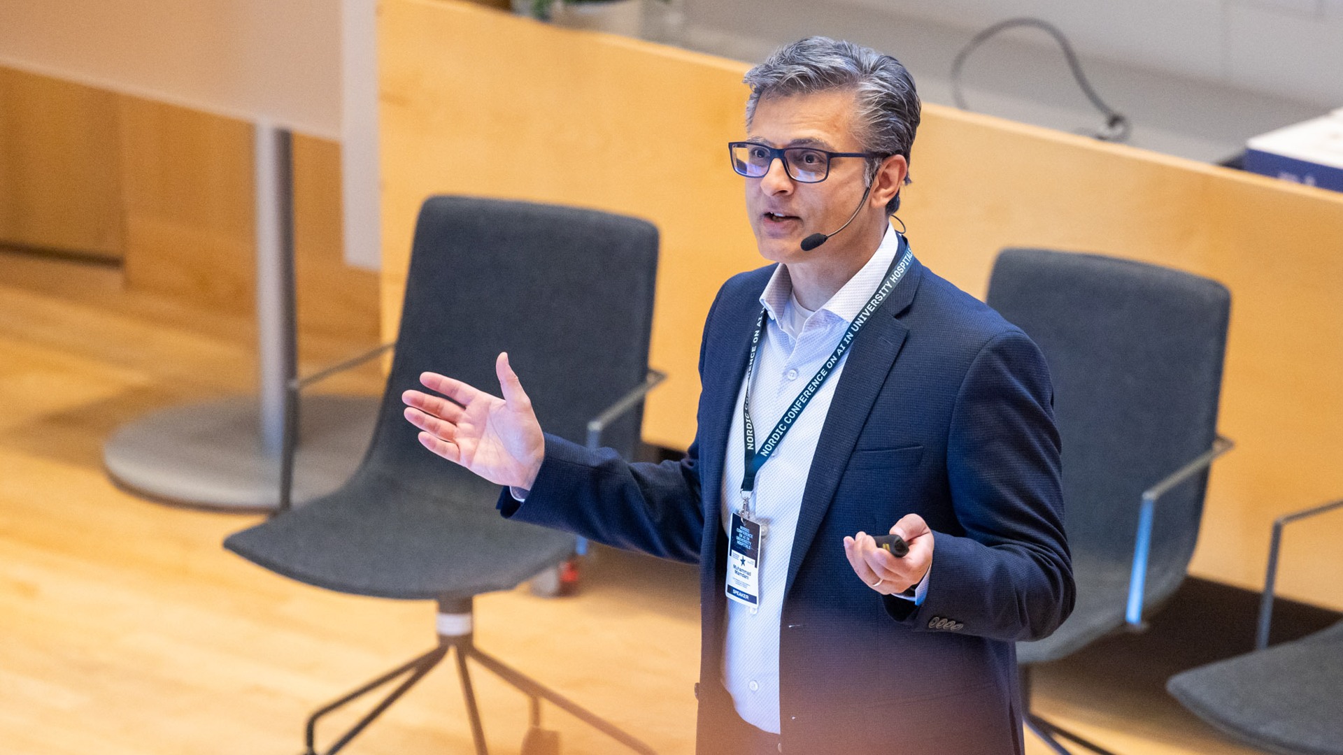 Muhammad Mamdani standing in front of a lecture hall.