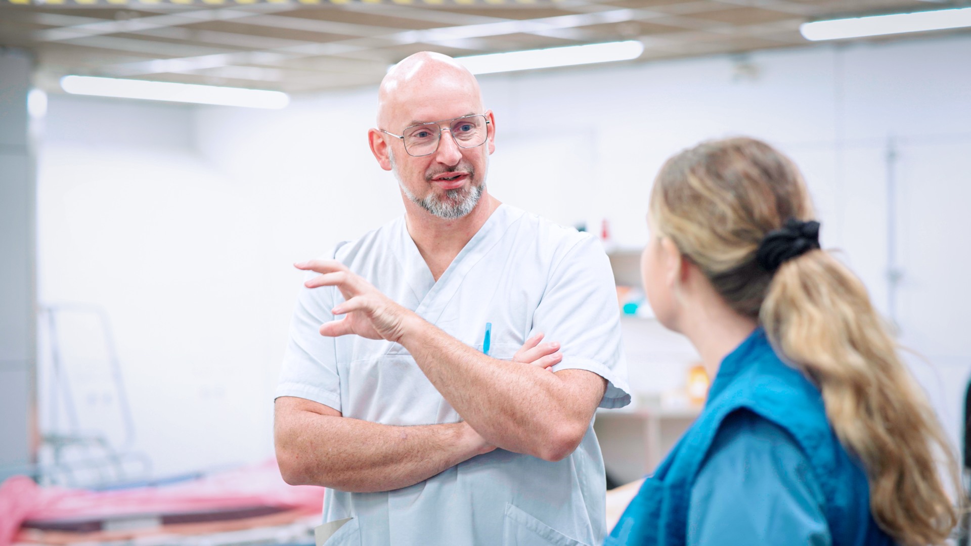 Joris Daems, Head Nurse, Emergency Department, UZ Leuven. talking to a nurse in a room.