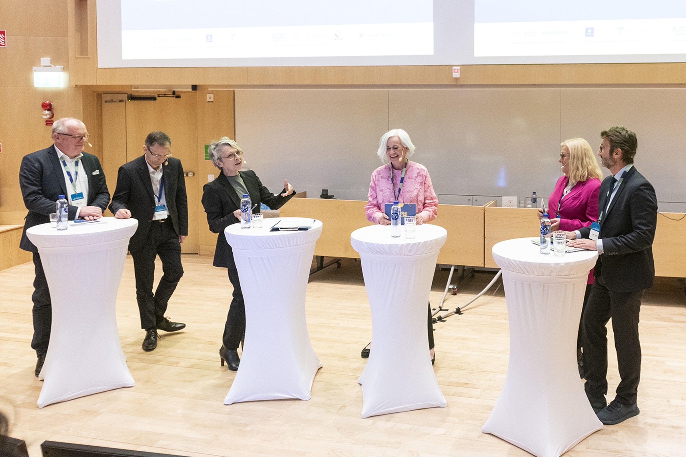 six people debating on stage