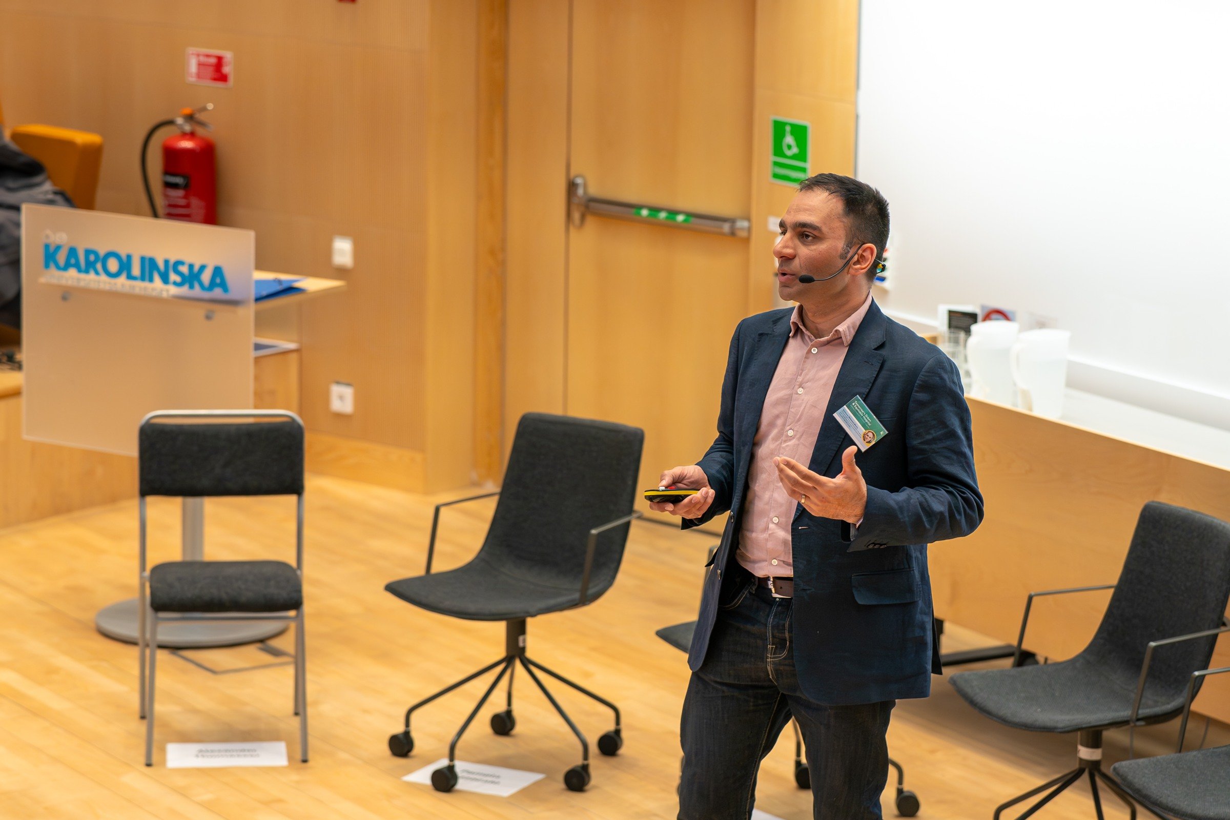 A man standing in front of a group of chairs.