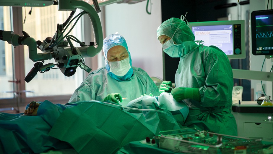 Medical doctors performing surgery.