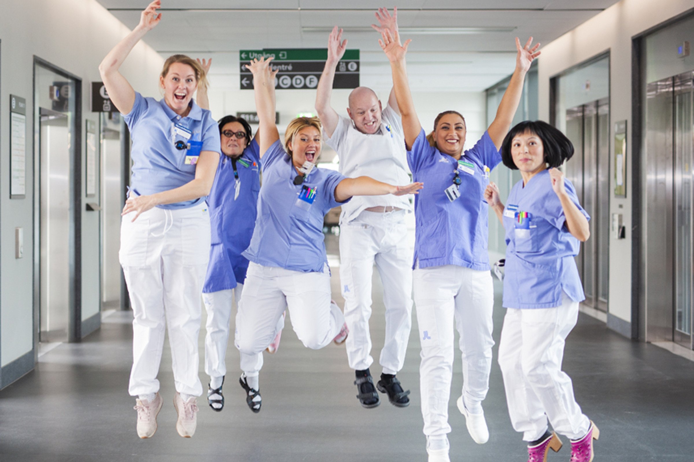 nurses jumping mid air, smiling