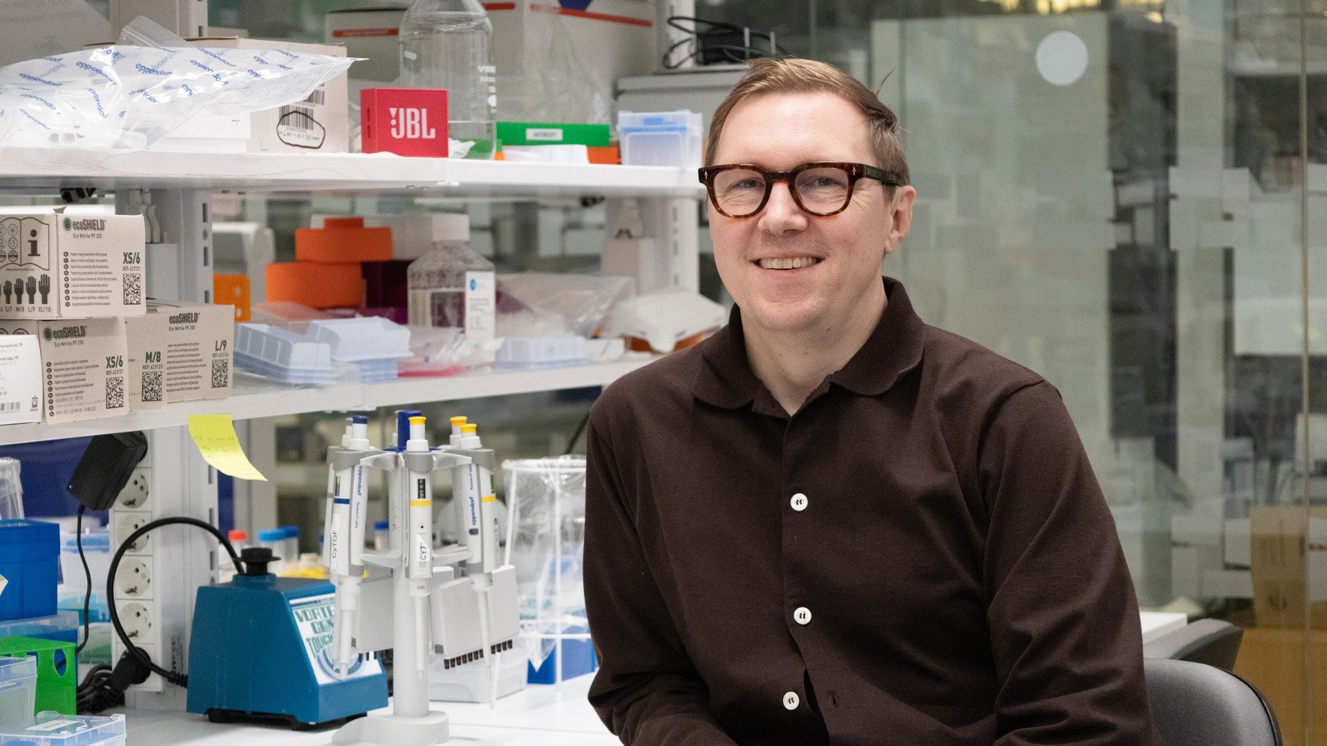 A man sitting at a desk in a lab.