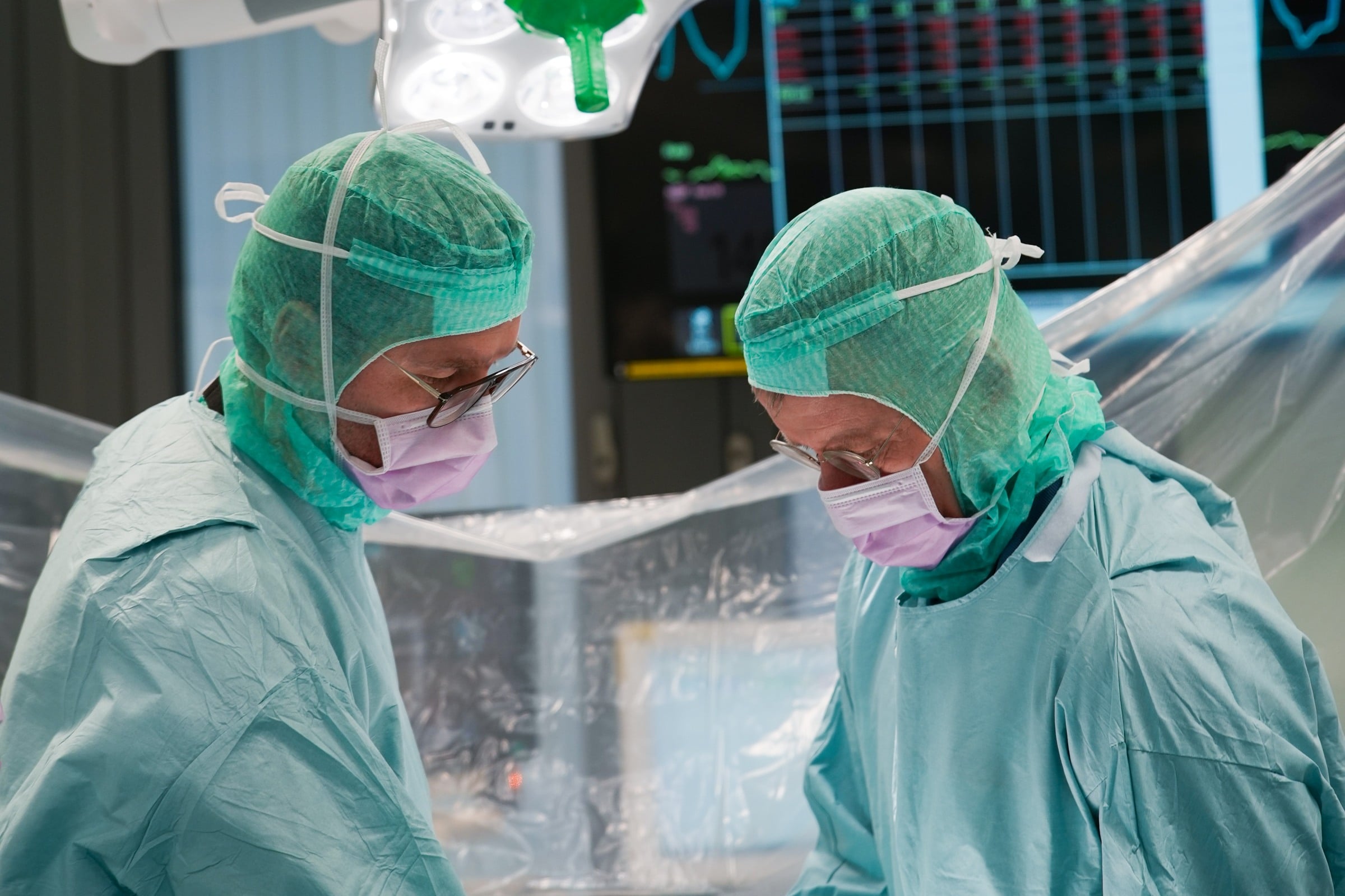 A couple of doctors standing in a room.