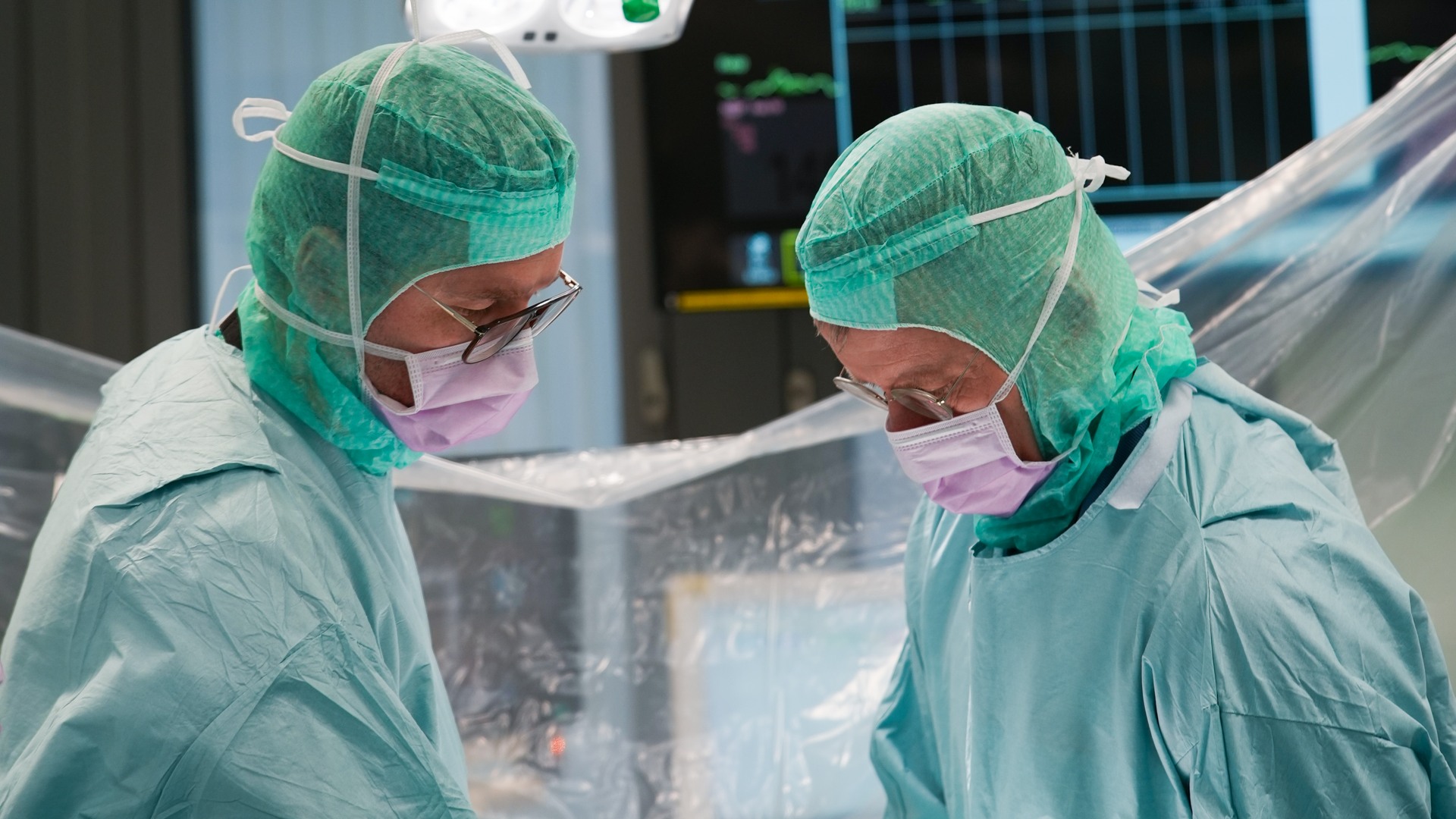 A couple of doctors standing in a room.