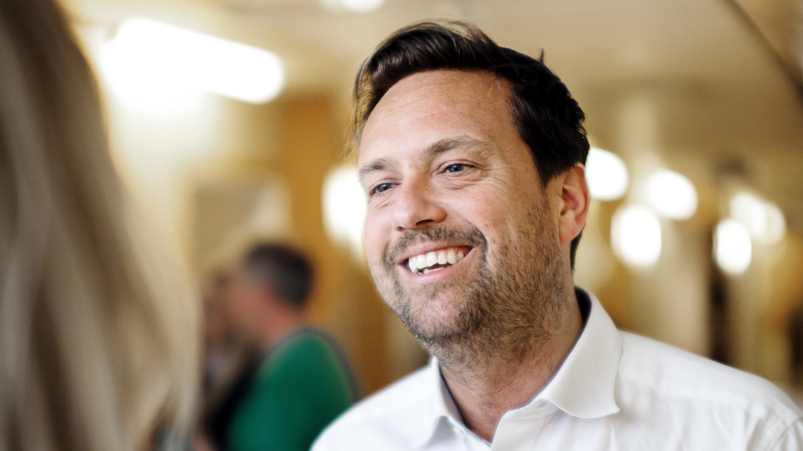 man in white shirt smiling